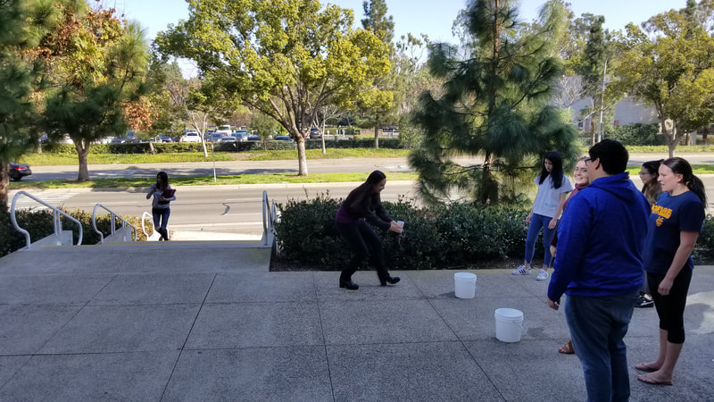 Students doing an activity with buckets